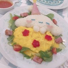 a white plate topped with rice covered in fruit and veggies