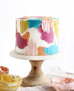 a multicolored cake sitting on top of a table