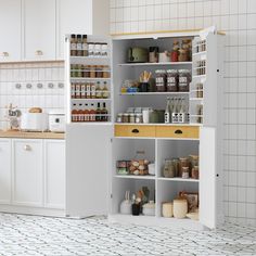 an open cabinet in the middle of a kitchen with lots of spices and condiments