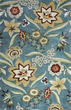 a blue rug with flowers and leaves on it