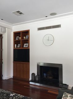 a living room with a fireplace and entertainment center