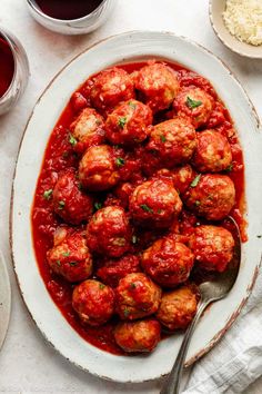 a white plate topped with meatballs covered in marinara sauce