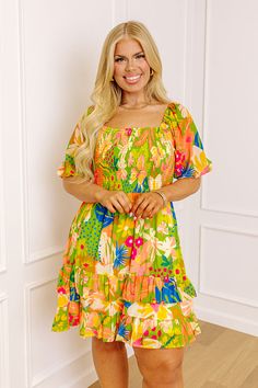 - Cabana life is calling with this flirty mini dress! - Colorful chiffon material with an abstract floral print - A built-in skirt lining - A scoop cut neckline - A smocked bodice - Short loose sleeves with elastic cuffs - A flowy and flattering silhouette that ends in a ruffled mini dress length hemline Measurements 1XL : Bust 32-34", Hip 40", Length 30", Sleeve Length 12", Waist 30-32". 2XL : Bust 34-36", Hip 42", Length 30", Sleeve Length 12.5", Waist 32-34". 3XL : Bust 36-38", Hip 44", Lengt Green Square Neck Flirty Dress, Green Tropical Print Mini Dress For Vacation, Green Floral Print Mini Dress For Brunch, Printed Green Mini Dress For Vacation, Green Printed Mini Dress For Vacation, Green Floral Print Summer Mini Dress, Green Tropical Dress With Vibrant Print, Tropical Green Dress With Vibrant Print, Green Tiered Mini Dress For Brunch