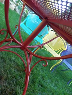 colorful chairs are sitting in the grass near each other