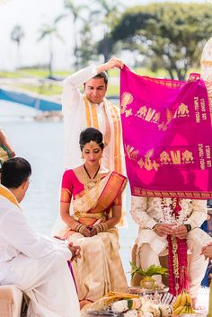 the bride and groom are getting ready for their wedding ceremony at the lake side venue