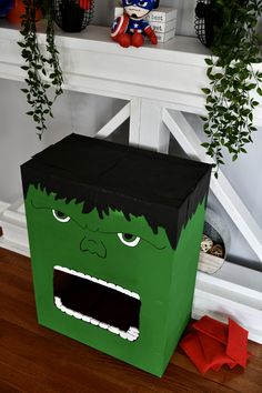 a green cardboard box with a face on it