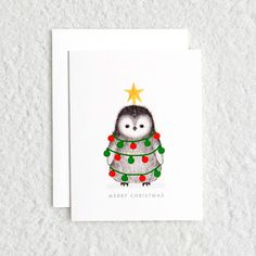 a christmas card with an owl wearing a sweater and a star on its head, sitting in front of a white background