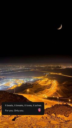 the night sky is lit up with bright lights, and there are mountains in the background