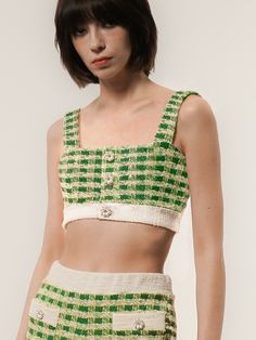 Editor's NotesInspired by teenage culture, this romantic knit top reinterprets the retro aesthetic with a funky style highlighted by the goth-glam accent.- Crafted from a cotton-blend bouclé knit tweed material in a green/ivory check pattern- Square neck and a cropped silhouette to add appeal to the item- The front open buttons adorned with faux pearl crystal buttons* The color in model photos may vary from the actual product due to lighting and staging; the actual color is closer to the product image.Measurements(in.)One Size(XS-M)- Chest: 14.96 in.- Shoulder: 8.66 in.- Hem (Waist): 12.60 in.- Shoulder Strap Length: 11.81 in.- Total Length: 6.69 in.* Model info: Height 5’ 81” Bust 30 Waist 23 Hip 35* Please note that detailed size measurements may have slight deviations based on the Chic Fitted Green Knit Top, Trendy Spring Party Knit Top, Retro Knit Tops For Spring, Fitted Cotton Knit Top, Trendy Fitted Cotton Knit Top, Retro Cotton Party Tops, Chic Green Knit Crop Top, Chic Green Knit Tops, Green Cotton Knit Top For Spring