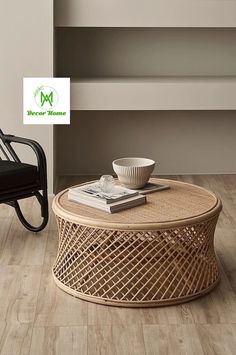 a coffee table with a bowl on it next to a black chair and bookcase