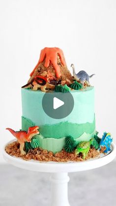 a cake decorated with dinosaurs on top of a white plate