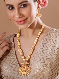 This jewelry set consists of a necklace and a pair of earringsGold-toned stone-studded necklace with intricate engraved detail, secured with an adjustable hook closureA pair of matching jumkas, secured with a post and back closure Size & Fit Necklace Length: 60 cmEarrings Length : 5 cm Material & Care Material: Brass Plating: Gold-platedStone type:Artificial BeadsWipe your jewellery with a soft cloth after every useAlways store your jewellery in a flat box to avoid accidental scratchesKeep sprays and perfumes away from your jewelleryDo not soak your jewellery in waterClean your jewellery using a soft brush, dipped in jewellery cleaning solution only Dispatch within 7 days Anarkali Lehenga, Ready To Wear Saree, Jewelry Cleaning Solution, Wedding Jumpsuit, Studded Necklace, Dress Jewelry, Wedding Wear, Cleaning Jewelry, Jewelry Set