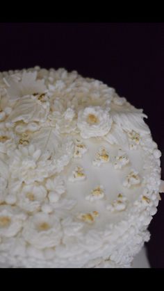 a cake with white frosting and flowers on it