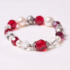 The Kate July Birthstone bracelet is a delicate and beautiful stretch bracelet in Swarovski crystal and finished with Balinese beads and sterling silver.  Each bracelet is unique and varies slightly.  This design incorporates shades of ruby red, clear crystal, cream, silver with Bali beads, stardust sparkle beads, and Swarovski pearls.  The actual piece can vary from the pictures shown due to the handmade nature and availability of materials.  Celebrate your favorite July birthday with a lovely easy to slip on stretch bracelet that is artfully and beautifully made.  Sparkles on your wrist and comfortable to wear.  Looks lovely stacked. Elegant Adjustable Crystal Stretch Bracelet, Silver Crystal Stretch Bracelet With Round Beads, Silver Stretch Bracelet With Crystal Round Beads, Elegant Red Stretch Bracelet With Gemstone Beads, Elegant Red Gemstone Beads Stretch Bracelet, Silver Crystal Stretch Bracelet, Elegant Crystal Bracelets With Spacer Beads, Elegant Faceted Stretch Bracelet As Gift, Elegant Crystal Beaded Bracelets With Faceted Details