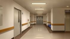 an empty hospital hallway with two elevators and no one in the room or waiting area