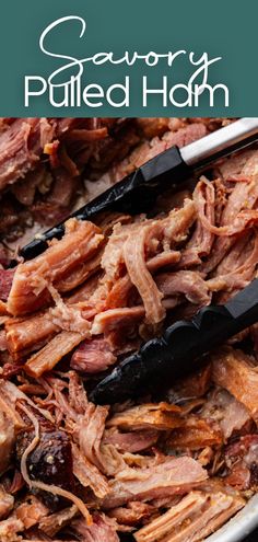 Close up image of tender pieces of juicy shredded pork with a tong