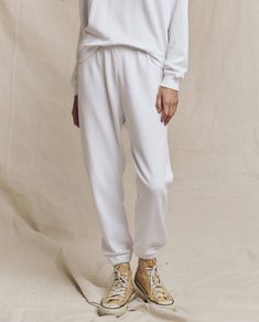 Person in The Stadium Sweatpant in True White from THE GREAT. FALL 24 KNITS and a matching sweatshirt, standing on a neutral background, wearing beige high-top sneakers. Vintage Athletic Wear, Emily And Meritt, Feminine Blouses, Athletic Wear, Two Pieces, Sweatpants, Angeles, Sweatshirts, How To Wear