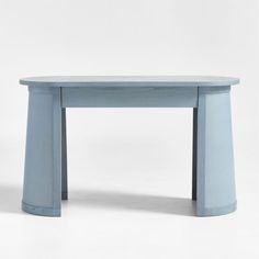 a blue table sitting on top of a white floor