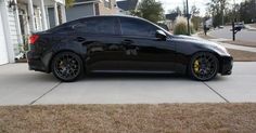 a black car parked in front of a house