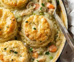 chicken pot pie with biscuits and vegetables in a skillet