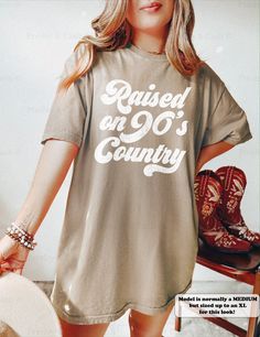 "The original creators of the \"Raised On 90's Country\" phrase. This vintage-style tee is perfect for any concert or a day out in Nashville! ⭐️ * I T E M * I N F O* ✦ Comfort Colors Unisex Shirt ✦ 100% Ring-Spun Cotton ✦ Printed using Direct To Garment style- Inks are printed directly into the fabric. ✦ Different sizing may effect placement of final design. ✦ Colors may differ slightly due to different user monitor and screen settings. 📏 * S I Z I N G * ✦ Shirts are true-to-size for UNISEX fit Tshirt Dress Country, Retro T-shirt With Letter Print For Country Concerts, Western Tshirt Dress, Vintage Slogan T-shirt For Concerts, Raised On 90s Country Shirt, Retro T-shirt For Summer Country Concerts, Retro T-shirt For Country Concerts In Summer, Raised On 90s Country, Crew Neck T-shirt For Country Concerts