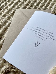 an open card with a handwritten poem on it sitting on top of a piece of paper