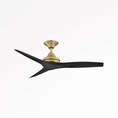 a gold and black ceiling fan against a white background with the blades pointing up to it