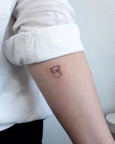 a person with a small tattoo on their arm and the outline of a koala bear