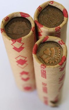 three rolls of chinese coins are shown in this photo