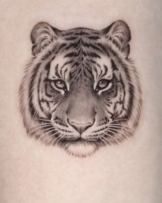 a tiger's head is shown in this tattoo