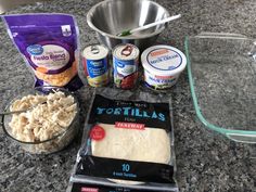 ingredients to make tortillas laid out on a granite counter top with measuring cups