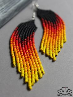 These fire red beaded earrings are made of high-quality Czech beads and strong synthetic thread. They are elegant, fashionable, and highly versatile, suitable for everyday wear. Features: Sterling silver components Color: black, red, yellow. This item is currently in stock. More beaded earrings http://etsy.me/2ycItdb Gerdan necklaces http://etsy.me/2mihf0J Beaded necklaces http://etsy.me/2Dkf1Fo Crochet necklaces http://etsy.me/2CAPdFc Back to shop https://www.etsy.com/shop/Namystynka Red And Black Beaded Earrings For Festival, Red And Black Beaded Festival Earrings, Handwoven Red Earrings, Red Handwoven Beaded Earrings For Festival, Beaded Earrings Black, Long Turquoise Earrings, Red Beaded Earrings, Fire Earrings, Turquoise Bead Earrings