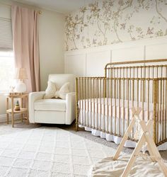 a baby's room with a crib and chair