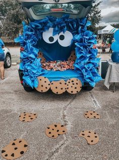 the back end of a car decorated with cookie cookies and blue paper towels as decorations