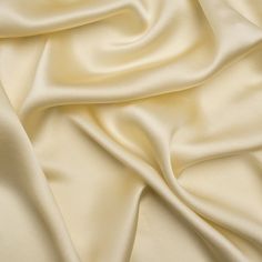 Turn creative mythology into fashion reality with this Famous Australian Designer Champagne Lightweight Silk Satin! The pale yellow face, featuring a stunning luster, looks like liquid gold as it drapes with an elegant fluidity. As delicate as the golden strings of Orpheus’s lyre, this divine fabric yields a heavenly softness that orchestrates a romantic look for your next formal events. Lean into quiet luxury with the simple silhouette of a slip dress, a flowing blouse, or a cowl neck gown. Lightweight and translucent; a lining will add structure and opacity if desired. Mood Designer Fabrics, Flowing Blouse, Mood Fabrics, Dress Forms, Lace Straps, Romantic Look, French Vanilla, Silk Charmeuse, Australian Design