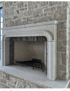 the fireplace is made out of stone and has a bench in it