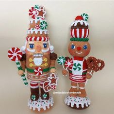 two knitted nutcrackers standing next to each other on a white surface