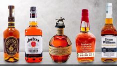 several different types of liquor bottles lined up on a counter