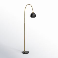 a black and gold floor lamp on an isolated white background with the light turned off