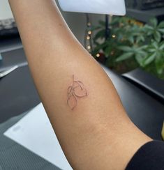 a person's arm with a small tattoo on the left side of their arm