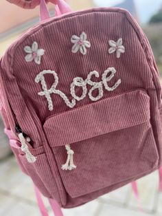 This item is a hand embroidered corduroy rucksack/ backpack MADE TO ORDER. This will be ready to dispatch in 2-4 weeks.  **PLEASE READ** The rucksack is ONE SIZE ONLY and is the perfect size for nursery or school! Each item is customised to your needs so if there is a design you are thinking of them please drop me a message.  If choosing an additonal small or large design please read:  Small designs include flowers, hearts, bees, roses.  Large designs include- rainbow, lion, dinosaur etc  The it Hand Embroidered Backpack, Bag Embroidery Backpacks, Custom Embroidery Backpack For Everyday Use, Embroided Backpacks, Everyday Backpack With Custom Embroidery, Everyday Use Backpack With Custom Embroidery, Embroidered Student Backpack, Embroidered Backpack For Students, School Backpack With Letter Embroidery