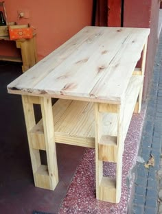 a wooden table sitting on top of a sidewalk