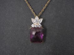 This beautiful estate pendant is gold vermeil over sterling silver. It features a 12x15mm synthetic purple sapphire accented by cubic zirconias. Measurements: 1/2 by 1 inch Marks: HC, 925 Comes on an 18 inch 14K Gold Filled chain. Condition: Excellent Gold Formal Necklace With Center Stone, Elegant Gold Necklace With Center Stone, Formal Gold Necklace With Center Stone, Gold Necklaces With Accent Stones For Formal Occasions, Sapphire Pendant Necklace, Sapphire Necklace Pendants, Purple Sapphire, Sapphire Pendant, Gold Filled Chain