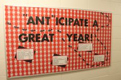 a red and white checkered bulletin board with words that read, anticipate a great year