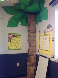 a classroom with a palm tree and bulletin board