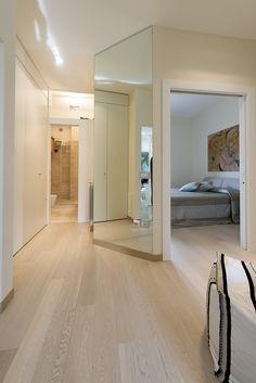 an empty room with white walls and wood flooring is shown in the foreground