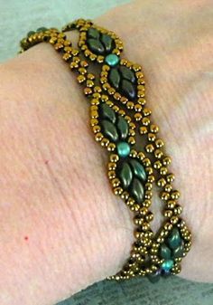 a close up of a person's arm wearing a bracelet with beads on it