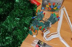 christmas lights are laid out on the floor next to an electrical cord and other items