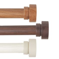 two wooden rollers and one white roller on a white background with clippings