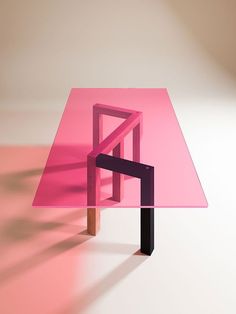 a pink table sitting on top of a white floor